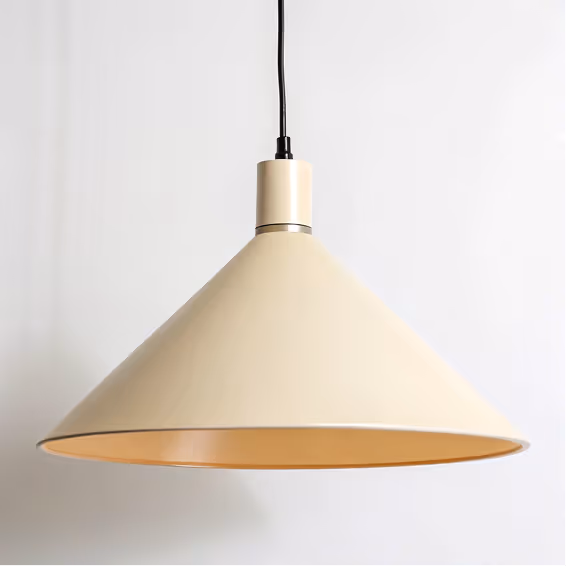 Beige modern conical pendant lamp hanging from a black cord against a white background.